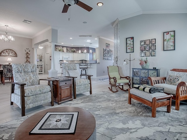 living room with lofted ceiling, light hardwood / wood-style floors, ornate columns, crown molding, and ceiling fan with notable chandelier