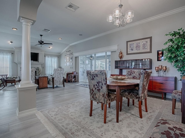 dining space featuring a wealth of natural light, vaulted ceiling, and ceiling fan with notable chandelier