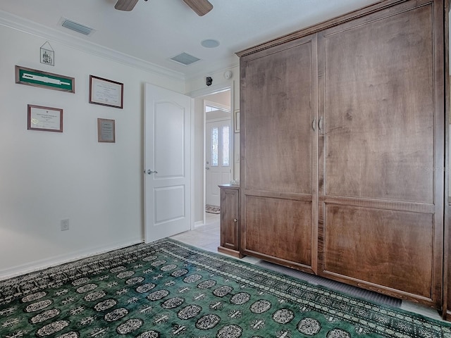 interior space featuring crown molding and ceiling fan