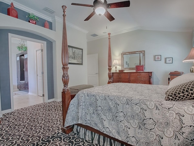 bedroom with lofted ceiling, ornamental molding, connected bathroom, and ceiling fan