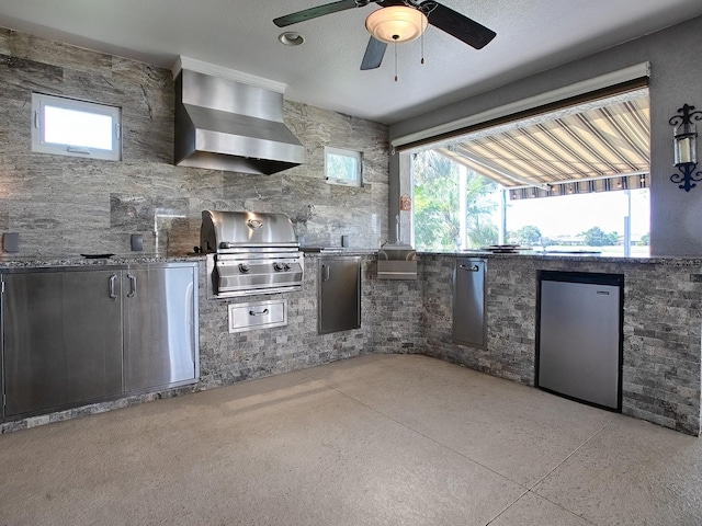 view of patio featuring ceiling fan, grilling area, and an outdoor kitchen