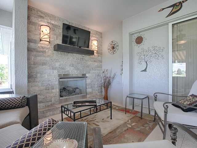 living room featuring a stone fireplace