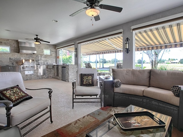 living room with ceiling fan and tile walls