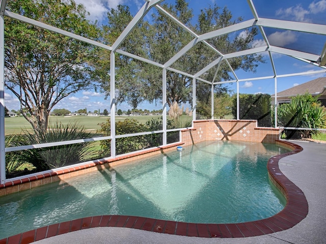 view of pool with a patio and glass enclosure