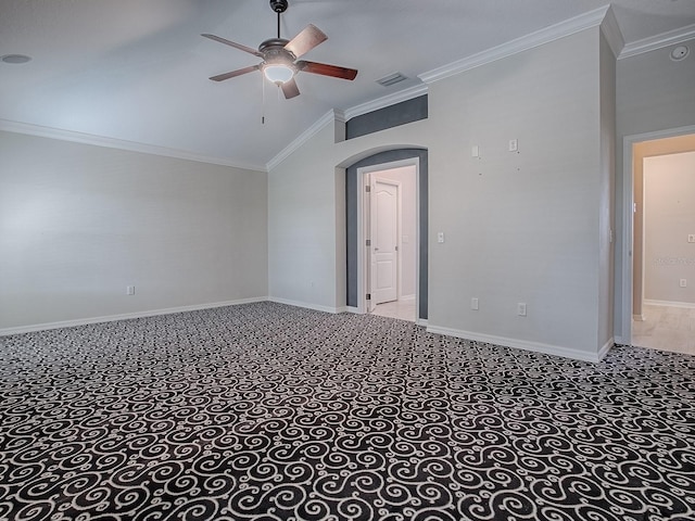 carpeted empty room with lofted ceiling, crown molding, and ceiling fan