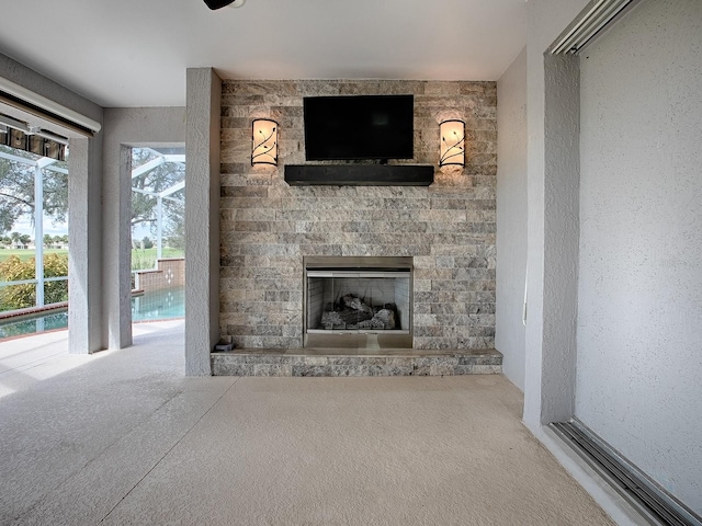 unfurnished living room with carpet floors and a fireplace