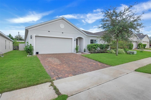 ranch-style house featuring a front yard and a garage