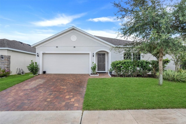 ranch-style home featuring a garage and a front lawn