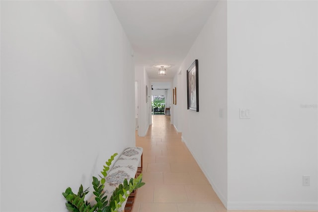 hall featuring light tile patterned floors