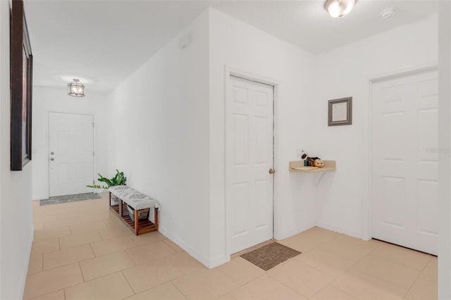 entryway with light tile patterned flooring