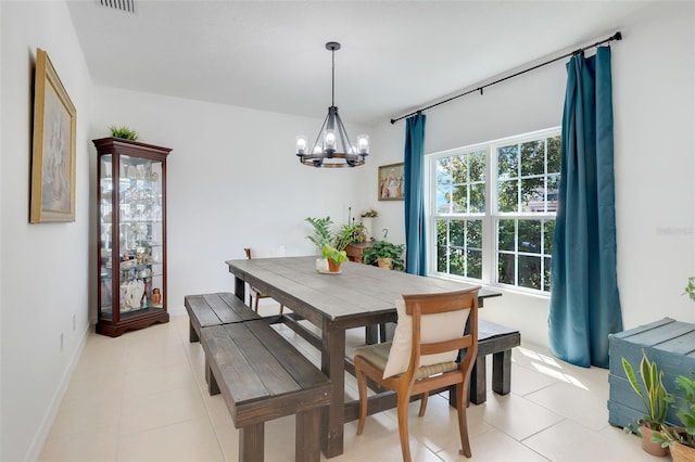 dining area featuring an inviting chandelier and light tile patterned floors