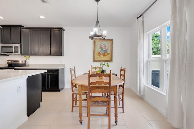 dining room with a chandelier and light tile patterned floors