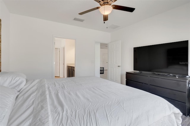 bedroom with ensuite bath and ceiling fan