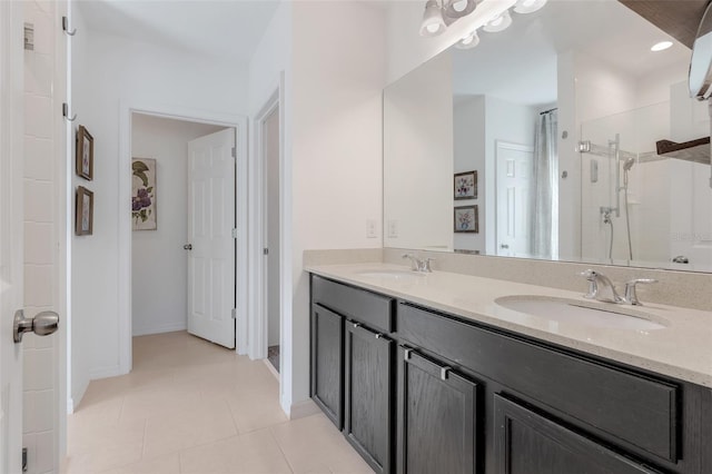 bathroom with tile patterned floors, walk in shower, and vanity