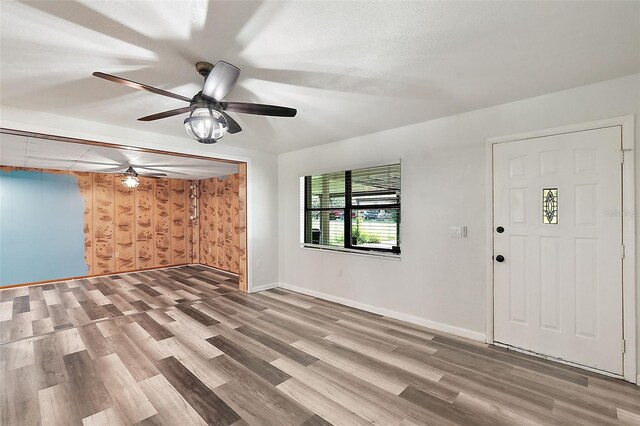 entrance foyer featuring ceiling fan, wood-type flooring, and a textured ceiling