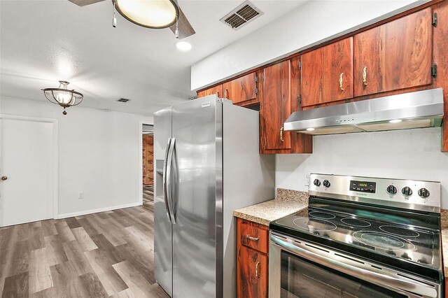 kitchen with wood-type flooring and appliances with stainless steel finishes