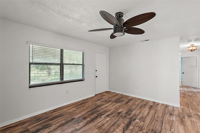 unfurnished room with ceiling fan, a textured ceiling, and hardwood / wood-style flooring