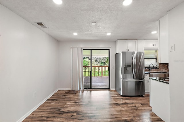 kitchen with white cabinetry, stainless steel refrigerator with ice dispenser, dark hardwood / wood-style flooring, and a textured ceiling