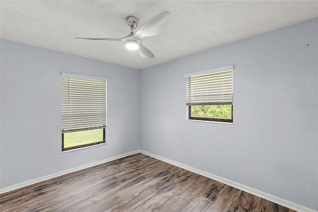 unfurnished room featuring ceiling fan, a textured ceiling, and light wood-type flooring