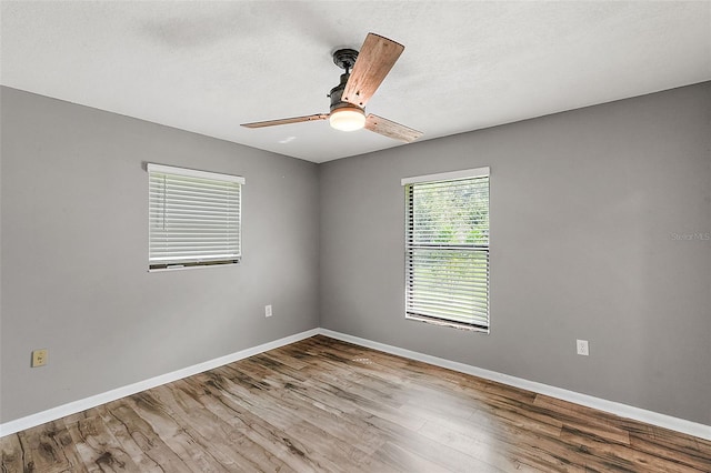 spare room with hardwood / wood-style floors and ceiling fan