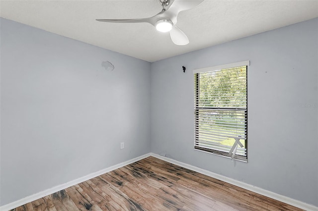 spare room featuring hardwood / wood-style floors and ceiling fan