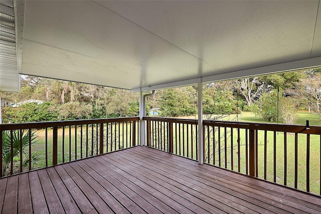 wooden terrace featuring a yard