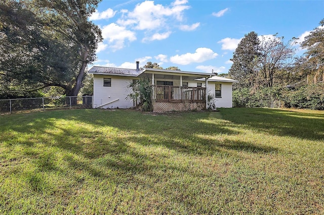 back of house with a lawn and a wooden deck