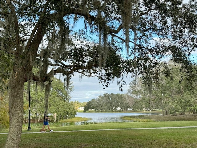 view of community with a lawn and a water view