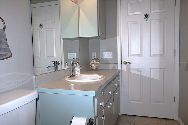 bathroom featuring toilet, vanity, and tile patterned floors