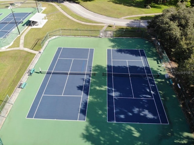 view of tennis court featuring basketball hoop