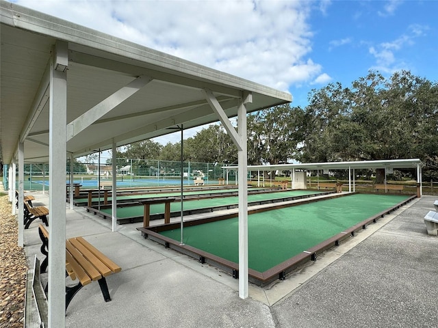 view of community featuring tennis court