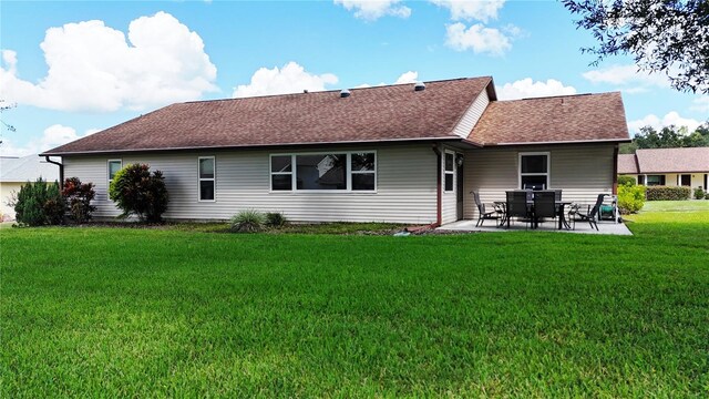 rear view of property with a patio area and a lawn