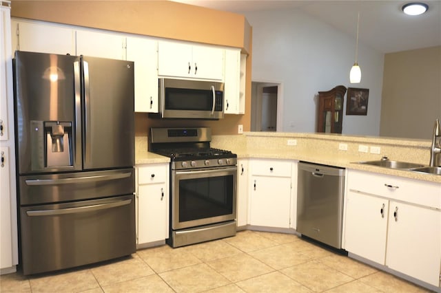 kitchen with stainless steel appliances, vaulted ceiling, sink, decorative light fixtures, and white cabinets