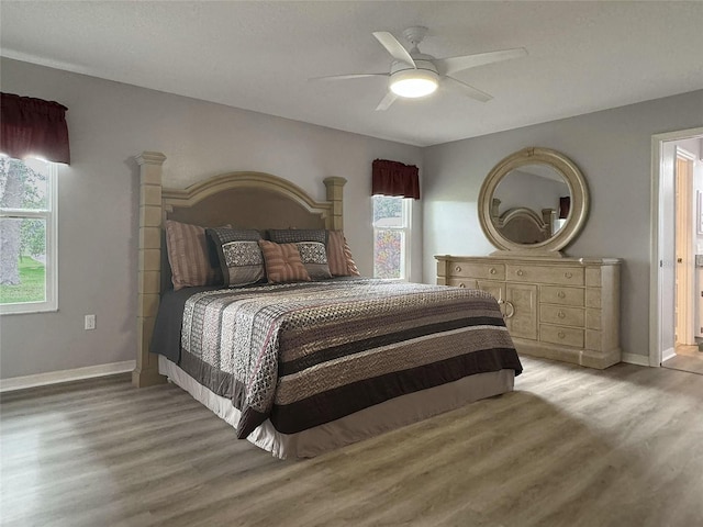 bedroom with ceiling fan and light hardwood / wood-style floors