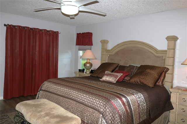 bedroom with hardwood / wood-style floors, a textured ceiling, and ceiling fan