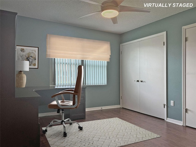 home office featuring a textured ceiling, dark hardwood / wood-style floors, and ceiling fan