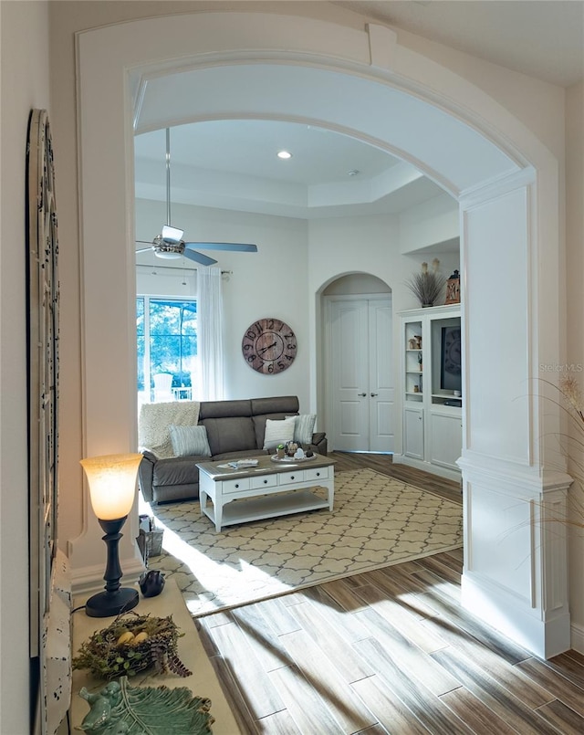 living room with hardwood / wood-style floors and ceiling fan