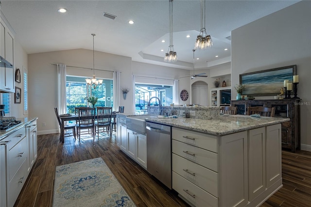 kitchen featuring a center island with sink, appliances with stainless steel finishes, hanging light fixtures, and white cabinets