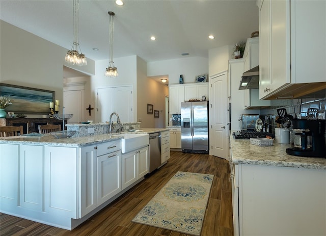 kitchen featuring white cabinetry, appliances with stainless steel finishes, and an island with sink