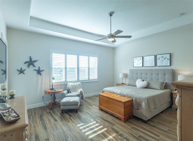 bedroom with ceiling fan and hardwood / wood-style flooring