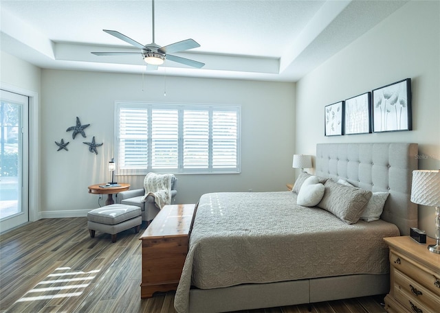 bedroom with dark hardwood / wood-style flooring, multiple windows, and ceiling fan