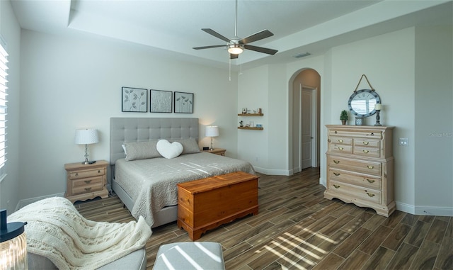 bedroom with ceiling fan and dark hardwood / wood-style floors