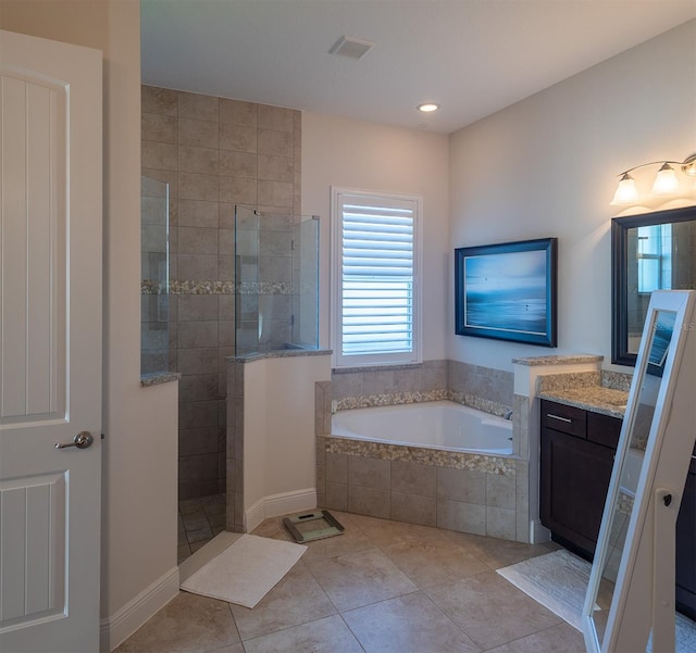 bathroom featuring vanity, shower with separate bathtub, and tile patterned flooring