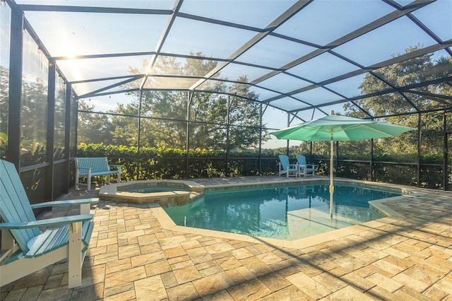 view of swimming pool with a patio area, a lanai, and an in ground hot tub