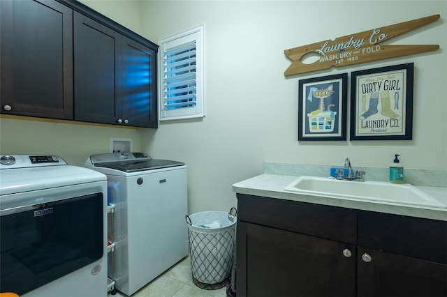 laundry area with cabinets, sink, washer and clothes dryer, and light tile patterned floors