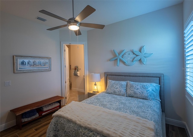 bedroom with dark hardwood / wood-style floors and ceiling fan