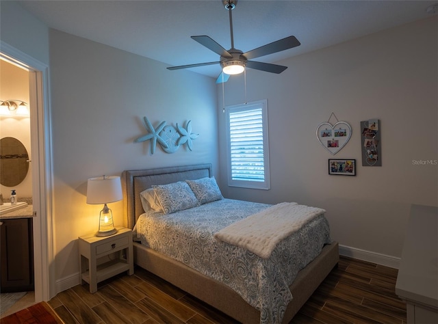 bedroom with ceiling fan, sink, and dark hardwood / wood-style floors