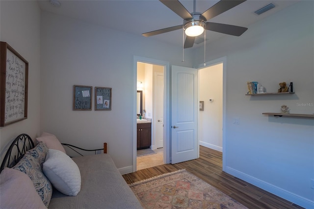 bedroom with ceiling fan, hardwood / wood-style flooring, sink, and ensuite bath