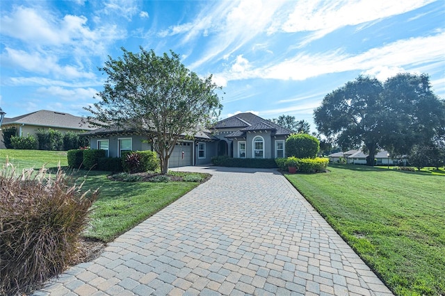 single story home featuring a front lawn and a garage