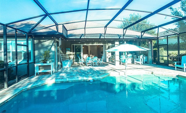 view of pool with a patio and a lanai